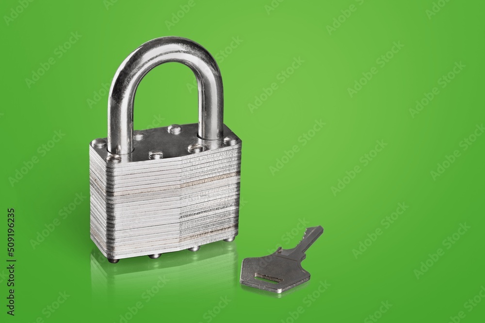 Simple lock and key. Small worn padlock with shiny key. Business data encryption, home security, or 