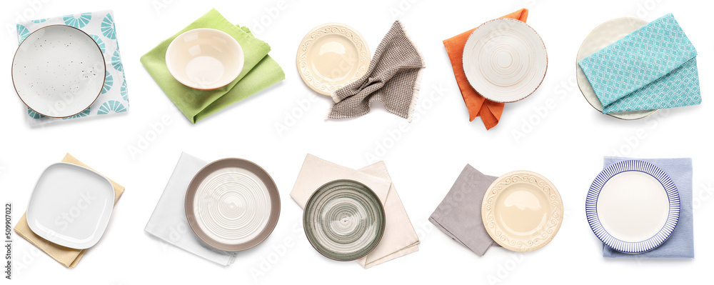 白色隔离的一套不同餐盘和餐巾纸