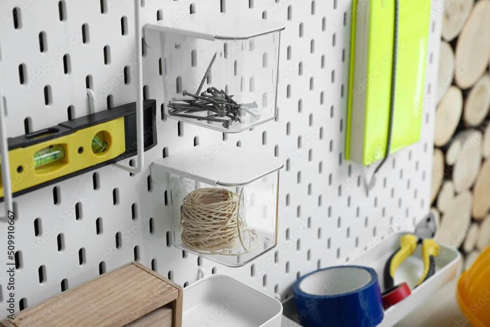 Closeup view of pegboard with different tools