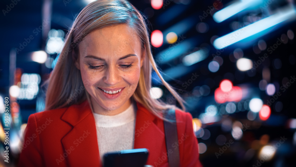 Close Up Portrait of a Beautiful Woman in Red Coat Walking in a Modern City Street with Neon Lights 