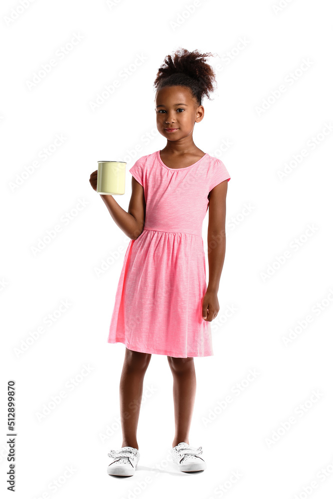 Little African-American girl with cup of tea on white background