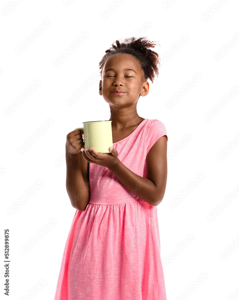 Little African-American girl with cup of tea on white background