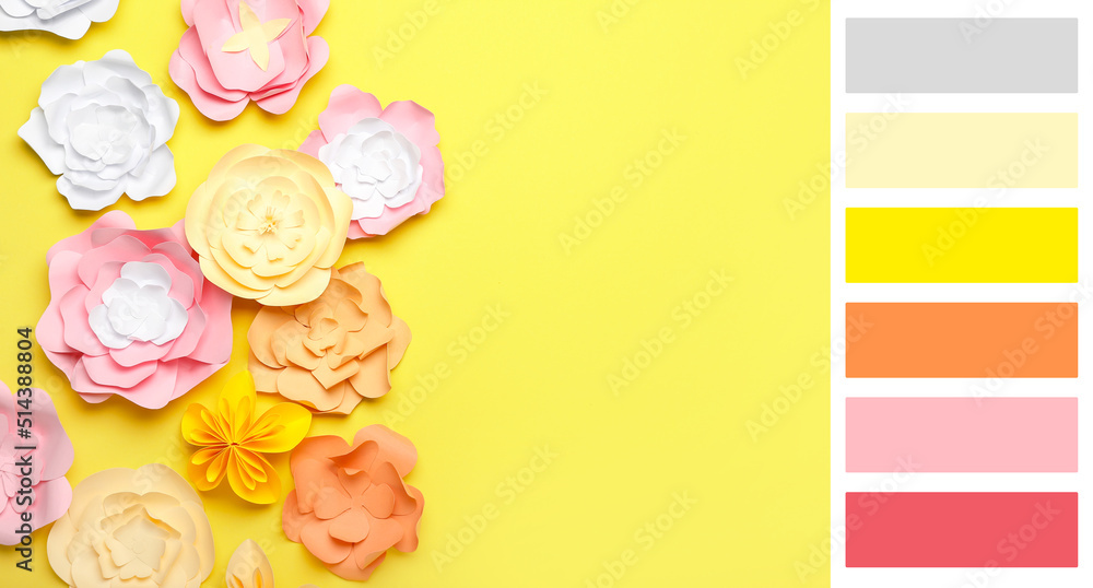 黄色背景上美丽的手工纸花。不同的颜色图案