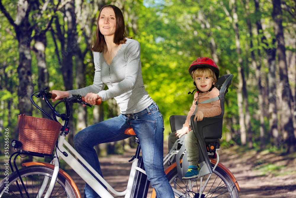Woman with little blond boy on e-bike at backseat
