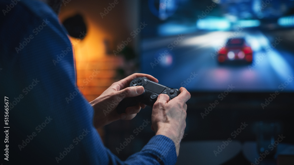Close Up on Mans Hands at Home, Sitting on a Couch in Stylish Loft Apartment and Playing Arcade Car