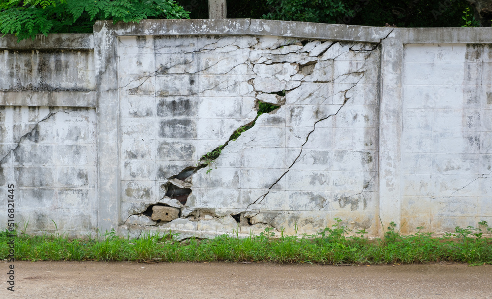 old white wall crack beside the road