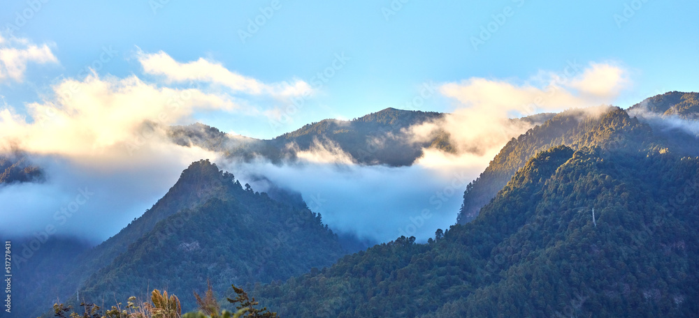 Beautiful landscape of a mountain with a cloudy blue sky on a summer day. Peaceful and scenic view o