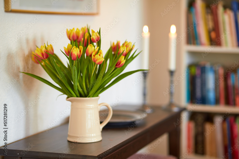 Bouquet of yellow tulips in a vase as a living room decoration or centrepiece symbolising love, affe