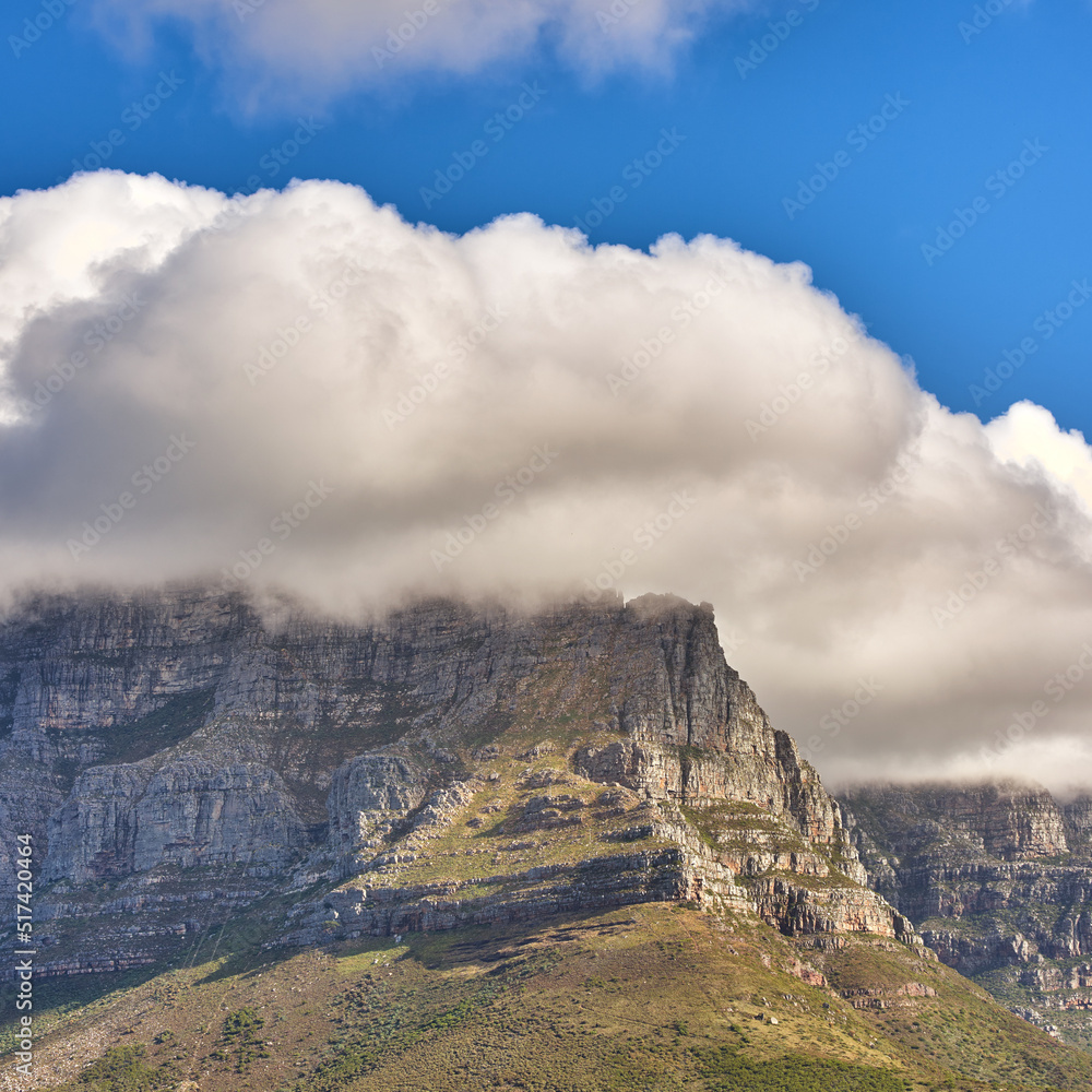 Clouds covering top of Table Mountain, Cape Town with copyspace. Cloud shape and shadow over rocky t