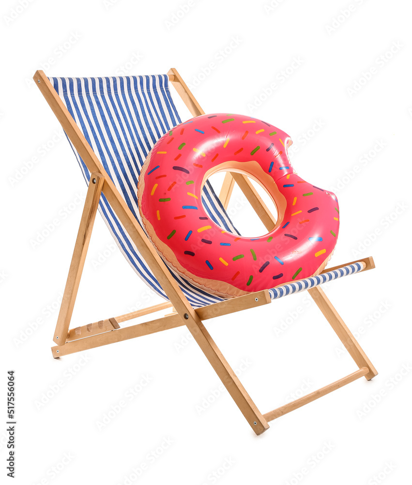 Striped deck chair with inflatable ring on white background