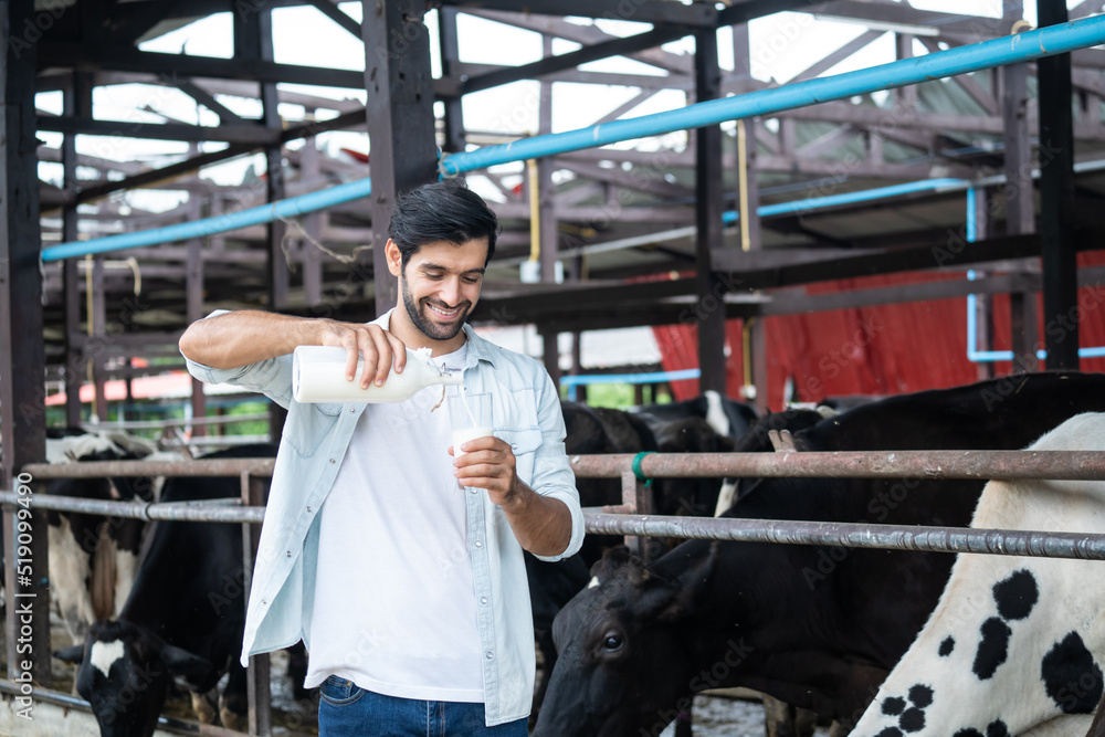 高加索男子奶农在牛棚喝牛奶的肖像