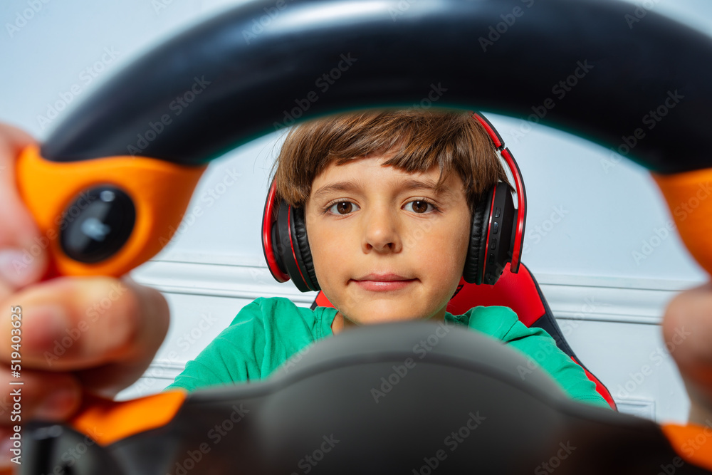 Through the steering wheel view of gamer boy play race game