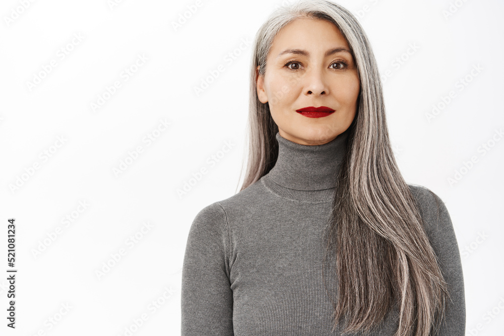 Aging and cosmetology concept. Portrait of beautiful and healthy middle aged asian woman with makeup