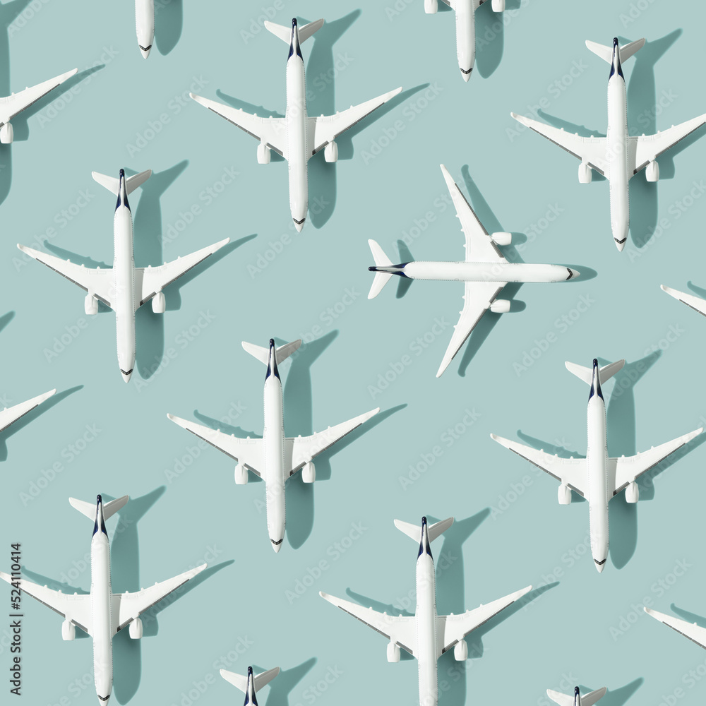 Creative composition made with passenger plane on blue background. Summer travel or vacation pattern