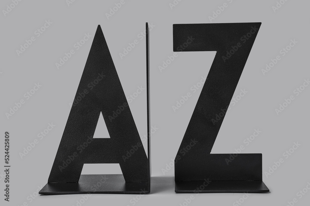 Black bookend in shape of letters on grey background