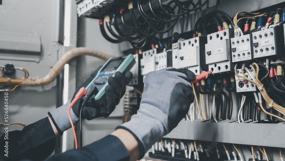 Electrician engineer tests electrical installations and wires on