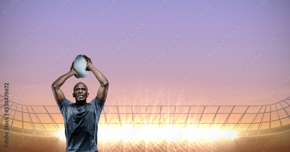 男子橄榄球运动员在体育场上空拿橄榄球的构成