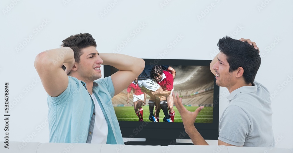 Composition of two male sports fans watching rugby match on tv