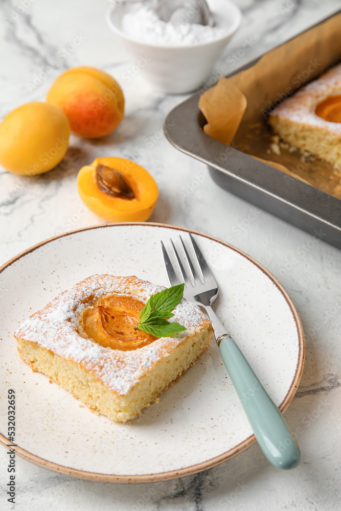 Plate with delicious apricot pie on light background, closeup