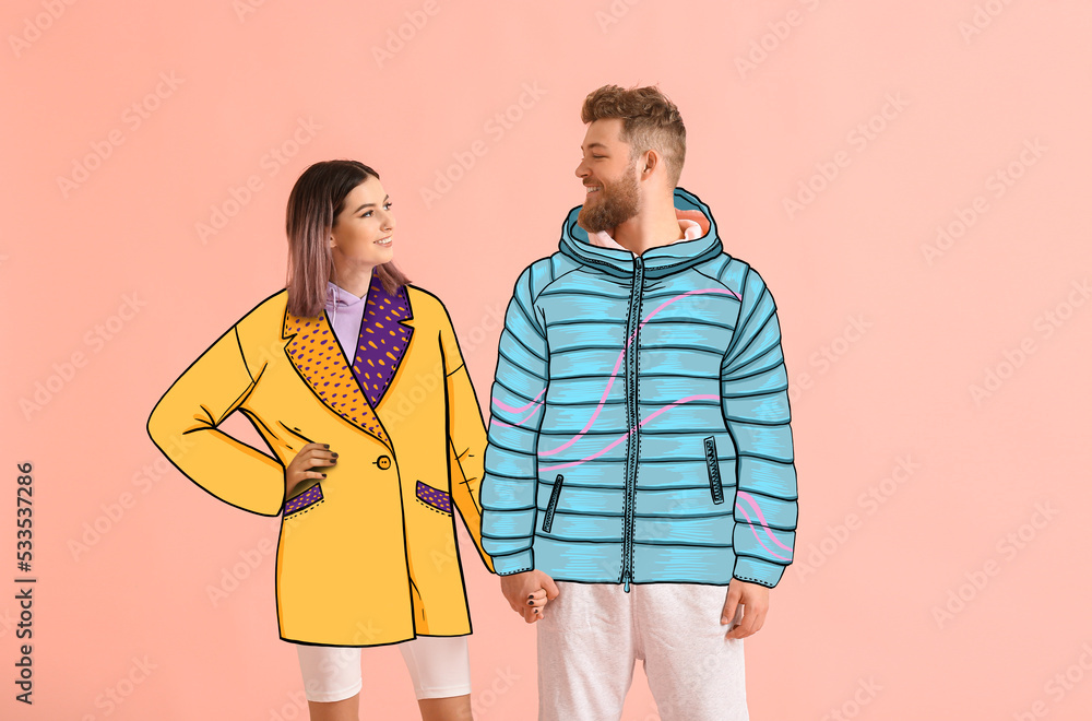幸福的年轻情侣穿着粉色背景的时尚彩绘外套