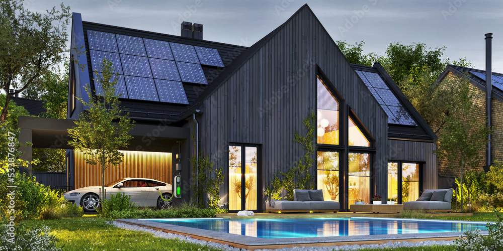 Night view of a beautiful modern houses with photovoltaic solar panels on the roof and electric vehi