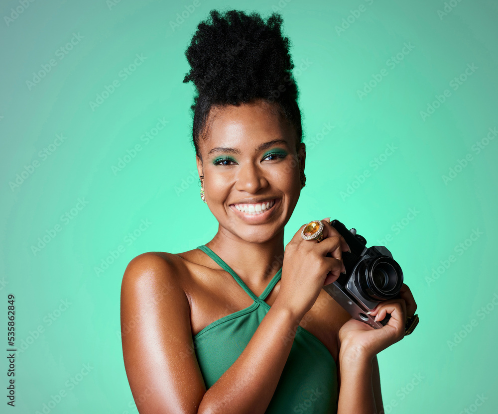 Photography, camera and portrait of a happy black woman standing in a studio with a green background