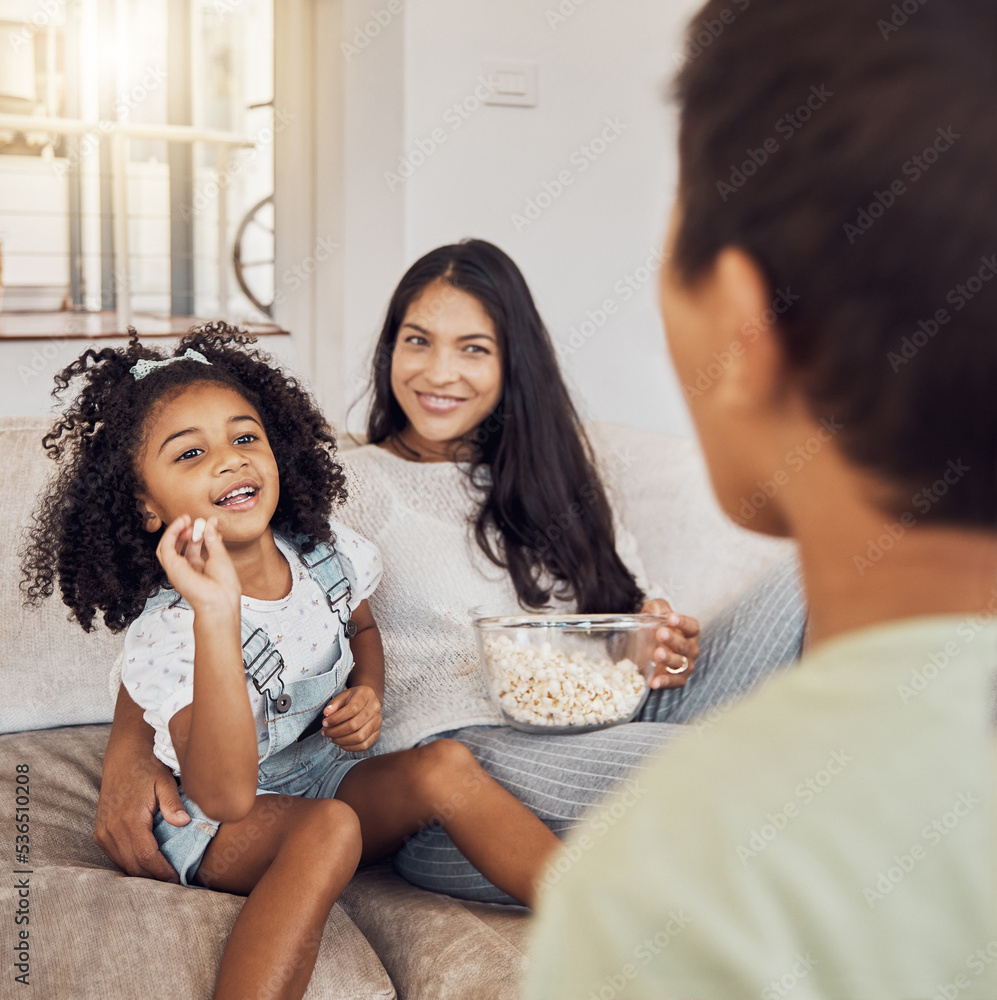 Mother, family and girl throw popcorn on sofa in home living room. Love, relax and child or kid with