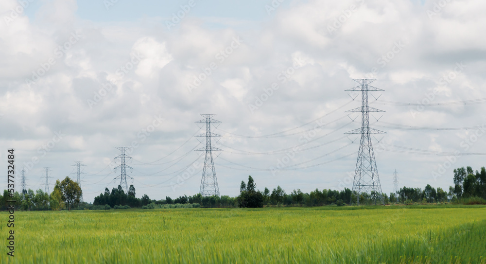 蓝天下的高压电线、输电塔和工业基础设施。