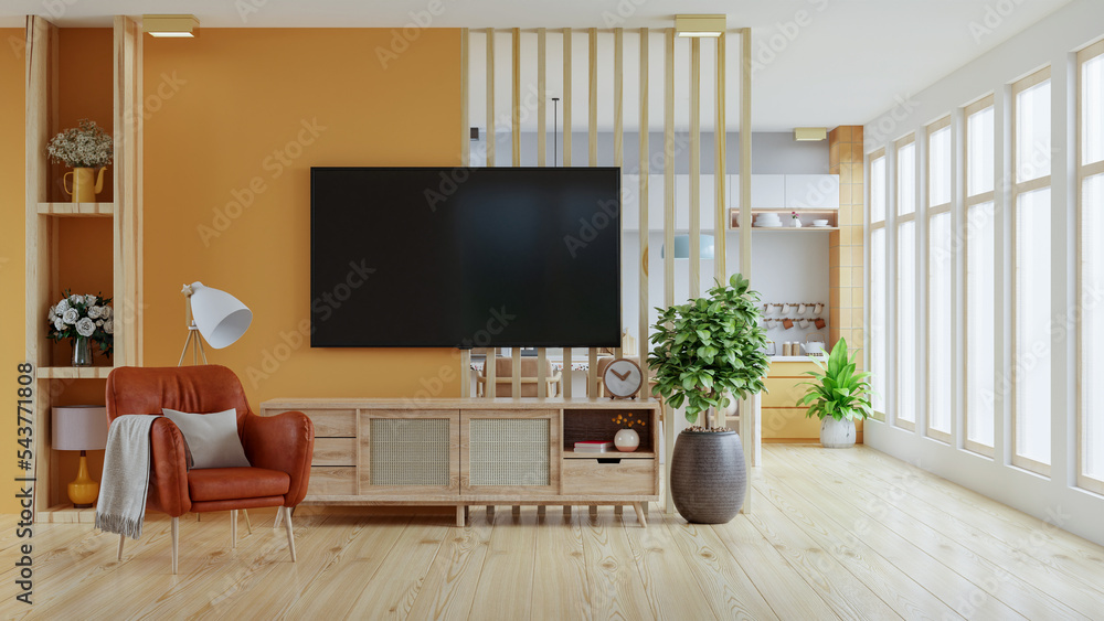 暖色调的房间电视模型在厨房前面有橙色的墙壁。