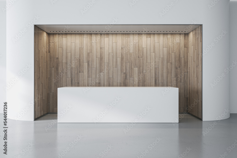 现代办公大厅内部，白色墙壁和木质安装的接待台。Hote