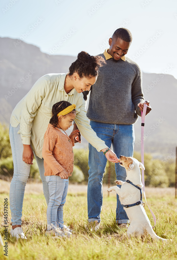 Happy family with a dog in nature to relax in summer holidays or vacation walking or playing with a 