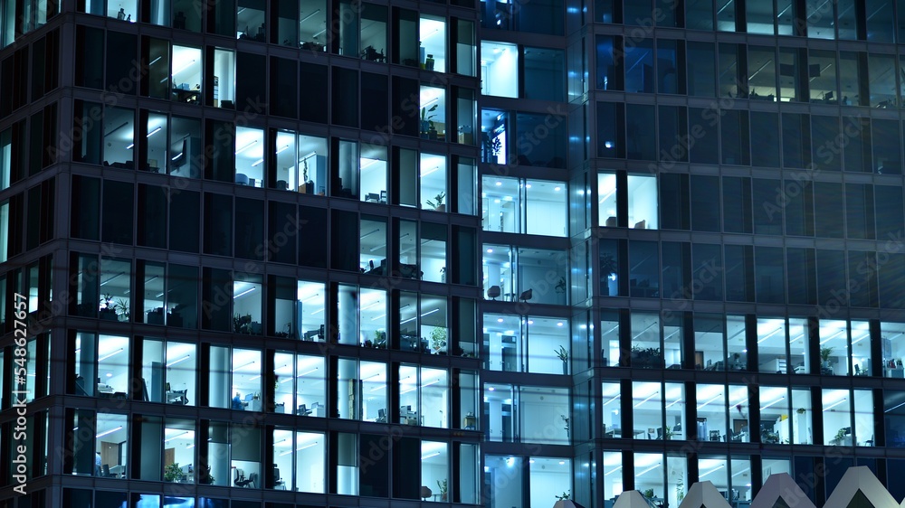 Modern office building in city at the night. View on illuminated offices of a corporate building. Bl