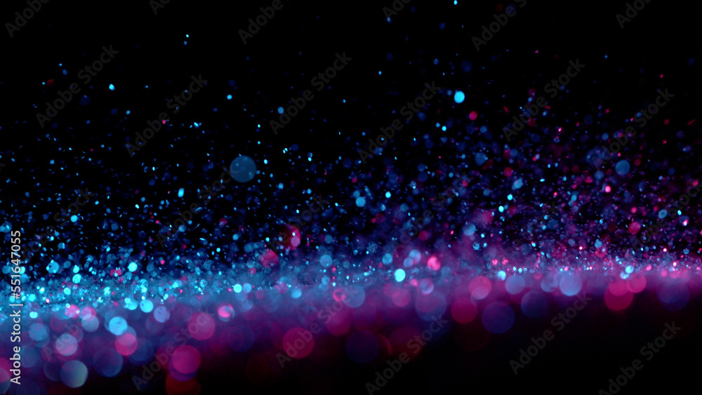 Neon bokeh background with neon colors on black.