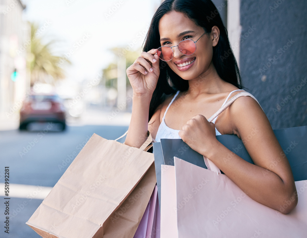 Retail, shopping bag and sunglasses with woman in city for summer, sales and products purchase. Luxu