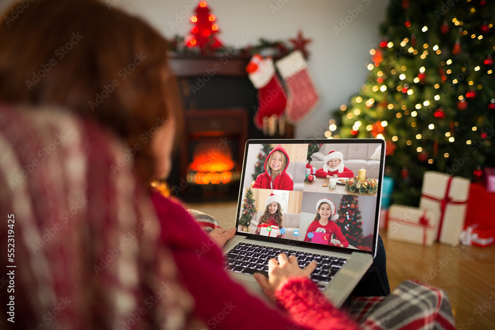 Caucasian woman with christmas decorations having video call with happy caucasian children