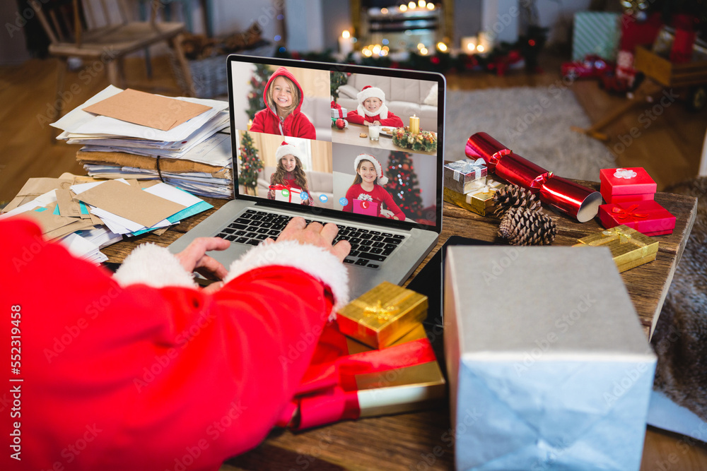 圣诞老人带着圣诞礼物与快乐的高加索儿童进行视频通话