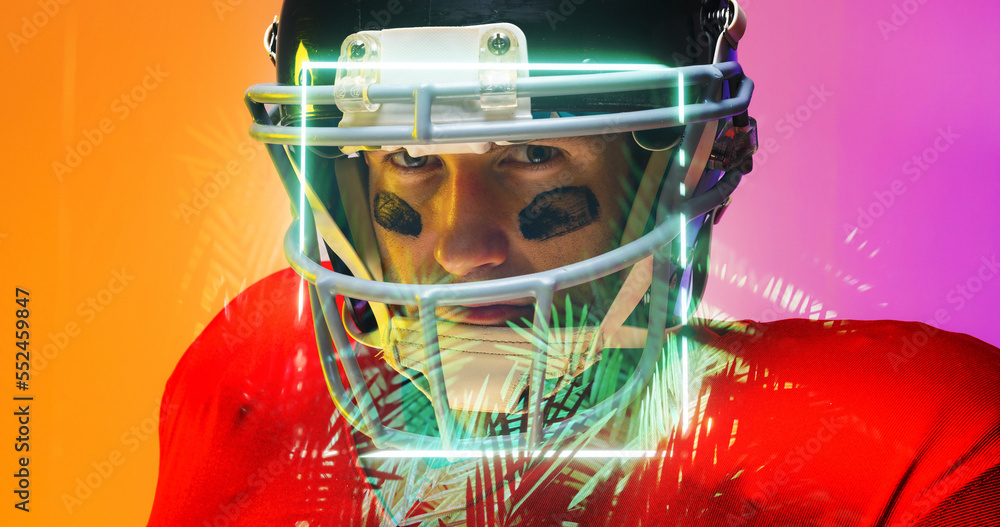 Close-up portrait of american football player wearing helmet by illuminated square and plants