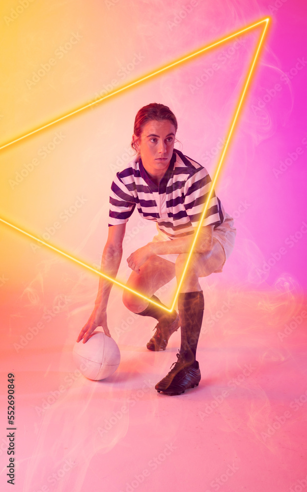 高加索女子橄榄球运动员，球在渐变背景上被照亮的三角形蹲下