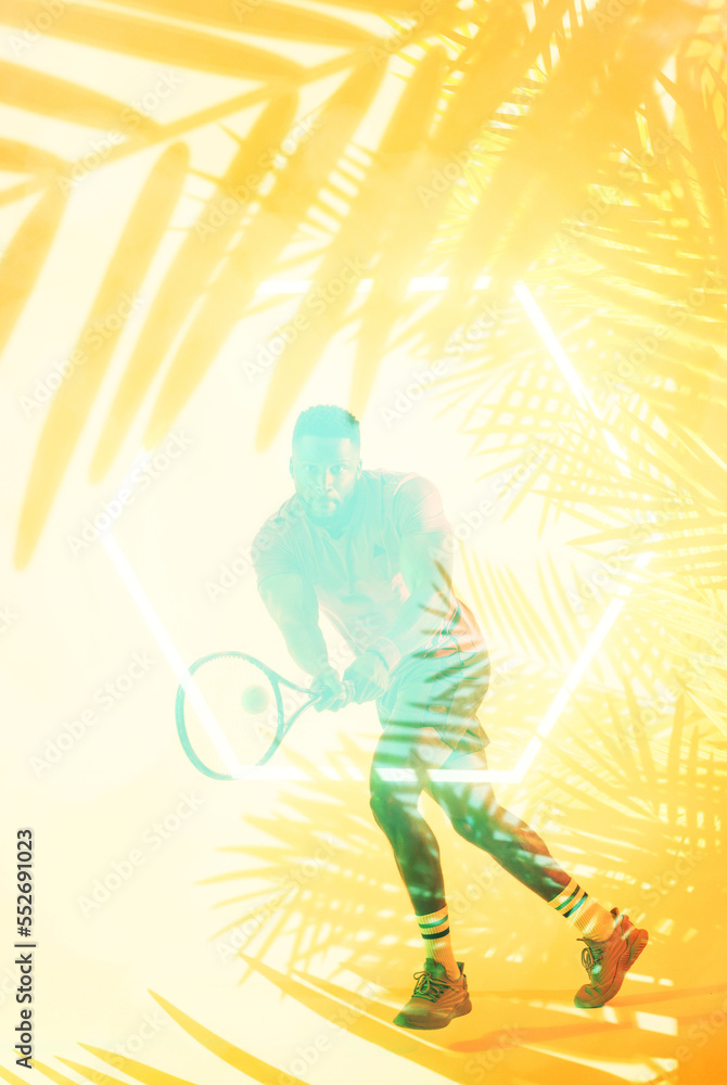 Full length of african american male tennis player hitting ball with racket over plants