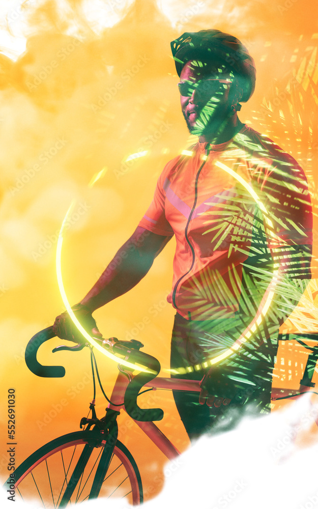 African american male cyclist on bike by illuminated circle and plants over smoky background