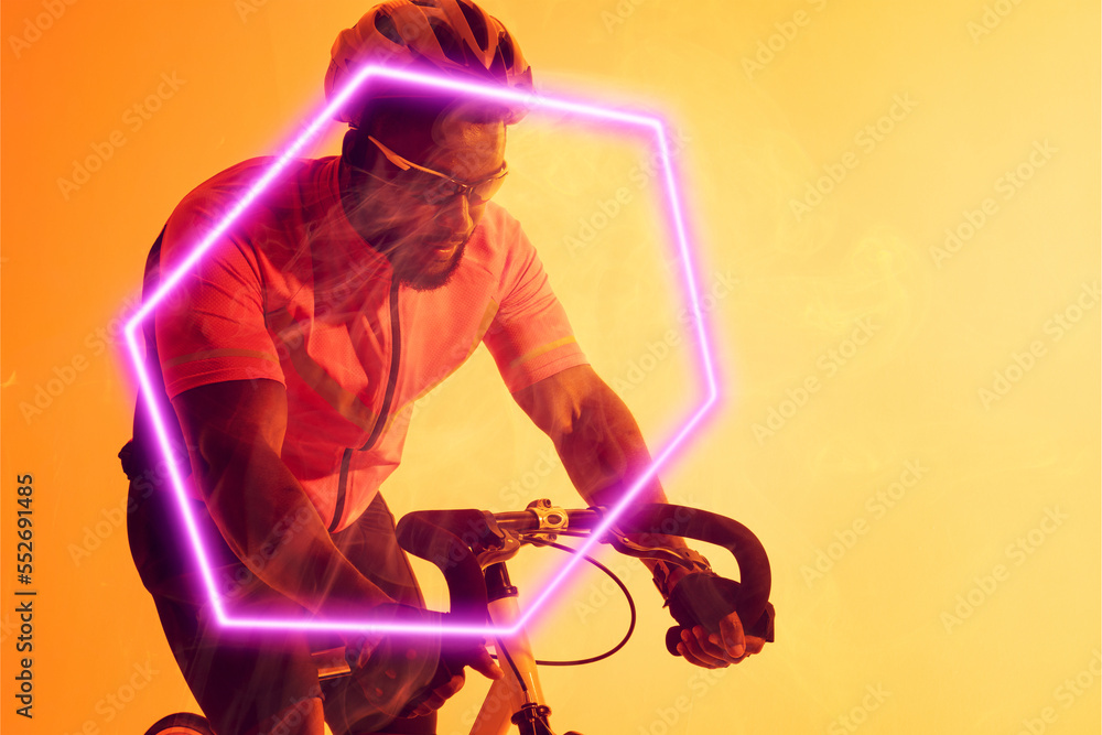 戴着头盔和眼镜的非裔美国男性自行车手骑着发光的六边形自行车