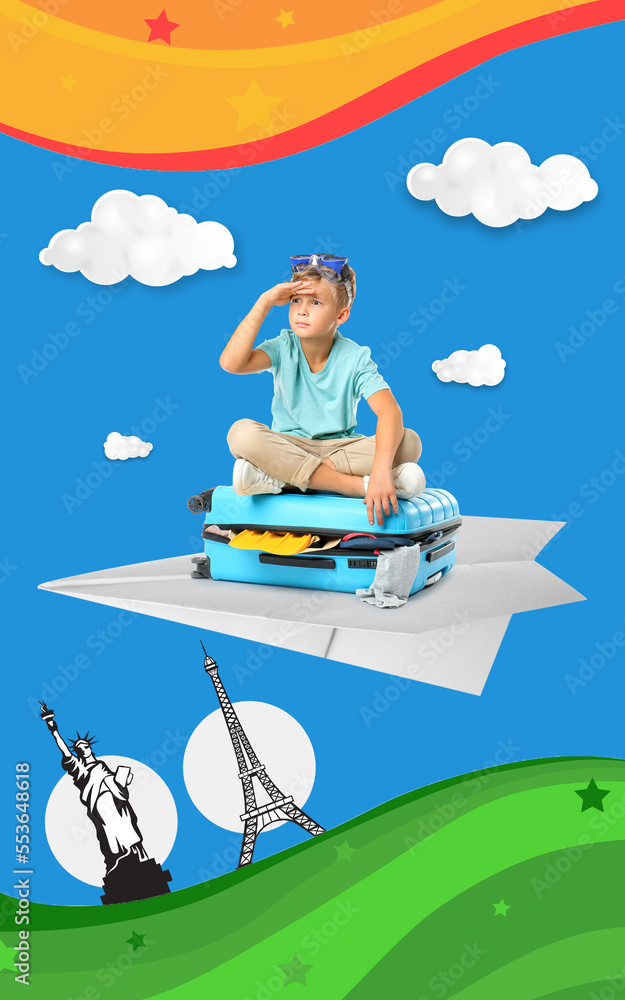 Cute little boy sitting on suitcase against white background