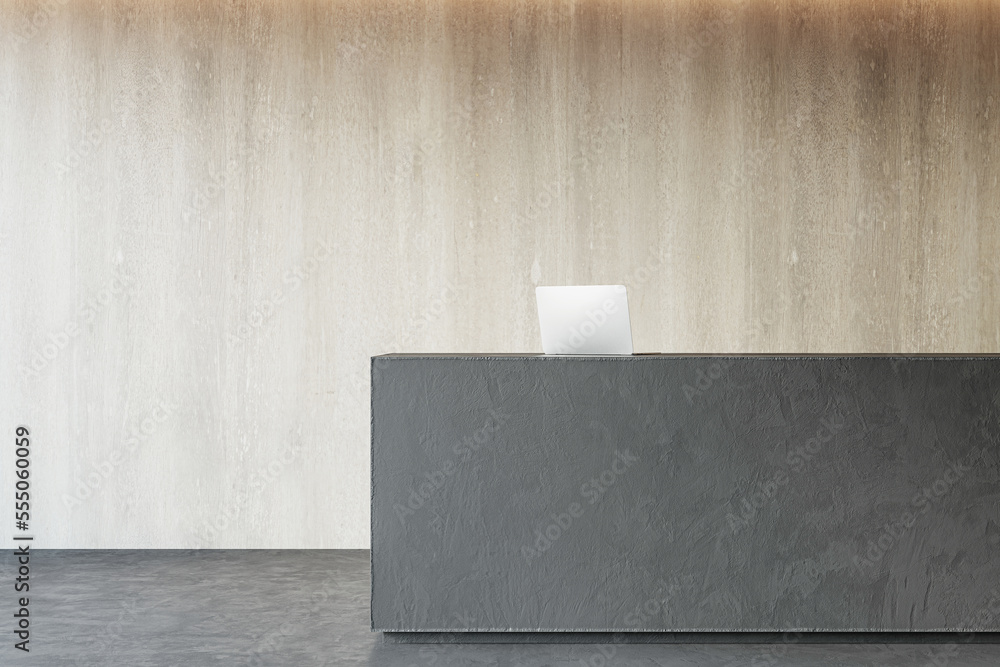 现代深色混凝土接待台正视图，浅色木墙背景上有笔记本电脑。3D re