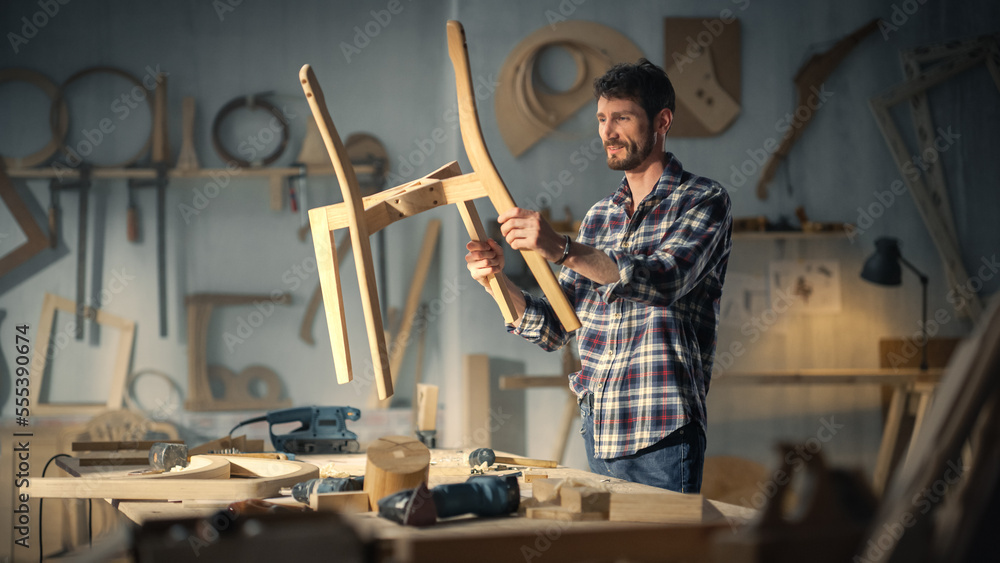 Young Stylish Carpenter Assembling Parts of a Wooden Chair. Professional Furniture Designer Working 