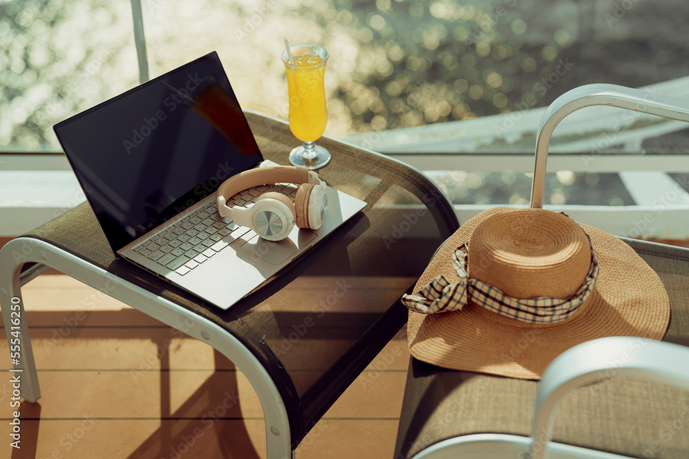 relax travel freelance working lifestyle ocean view balcony terrace with laptop and headphone remote