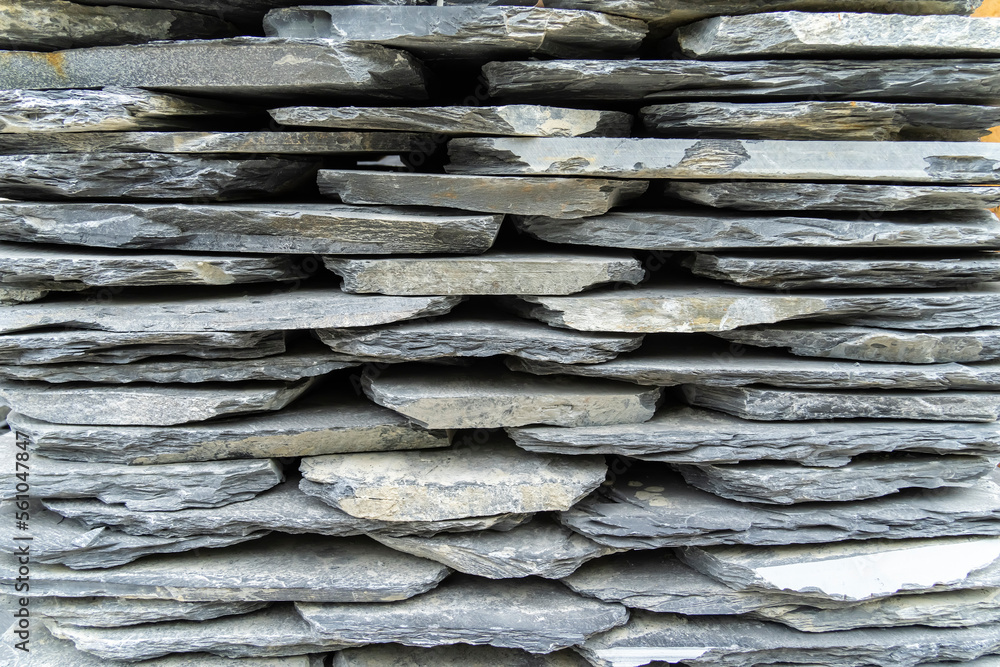 Stack flat slate stones cladding of wall used for flooring, walkways or wall decoration.Background t