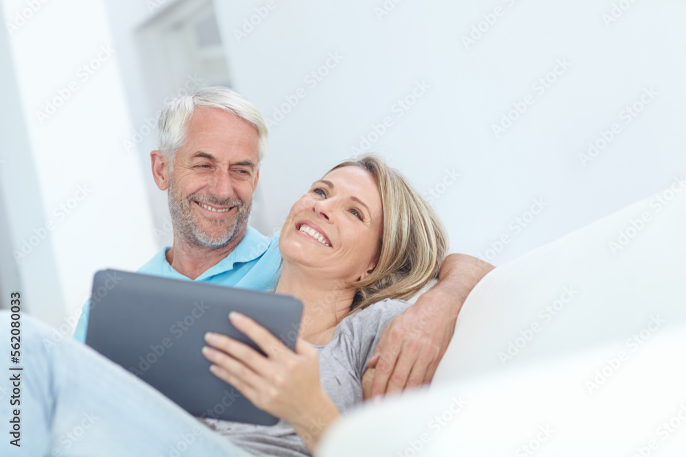 Senior, tablet and couple on a house couch on technology laughing and watching a movie on tech, Home