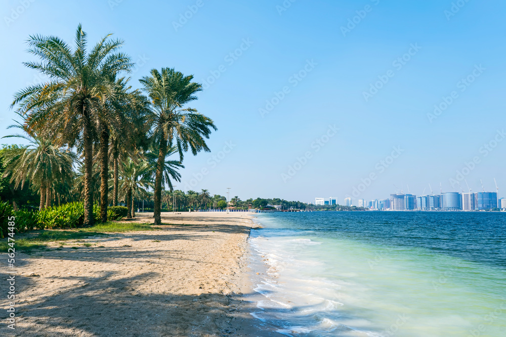 beautiful sandy beach with white sand in city park on the background of the sea and the bridge. Duba