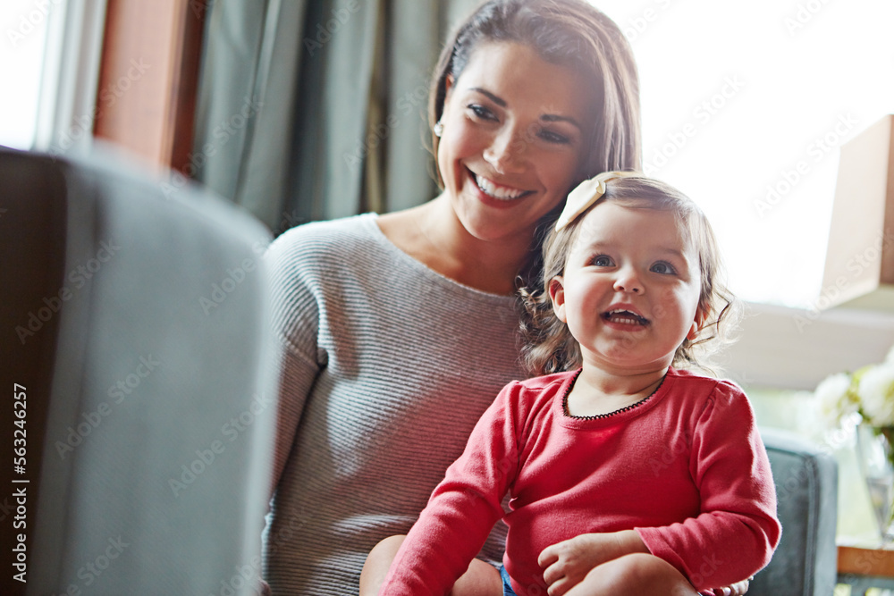 Family, children or love with a mother and girl together in the living room of their home, sitting o