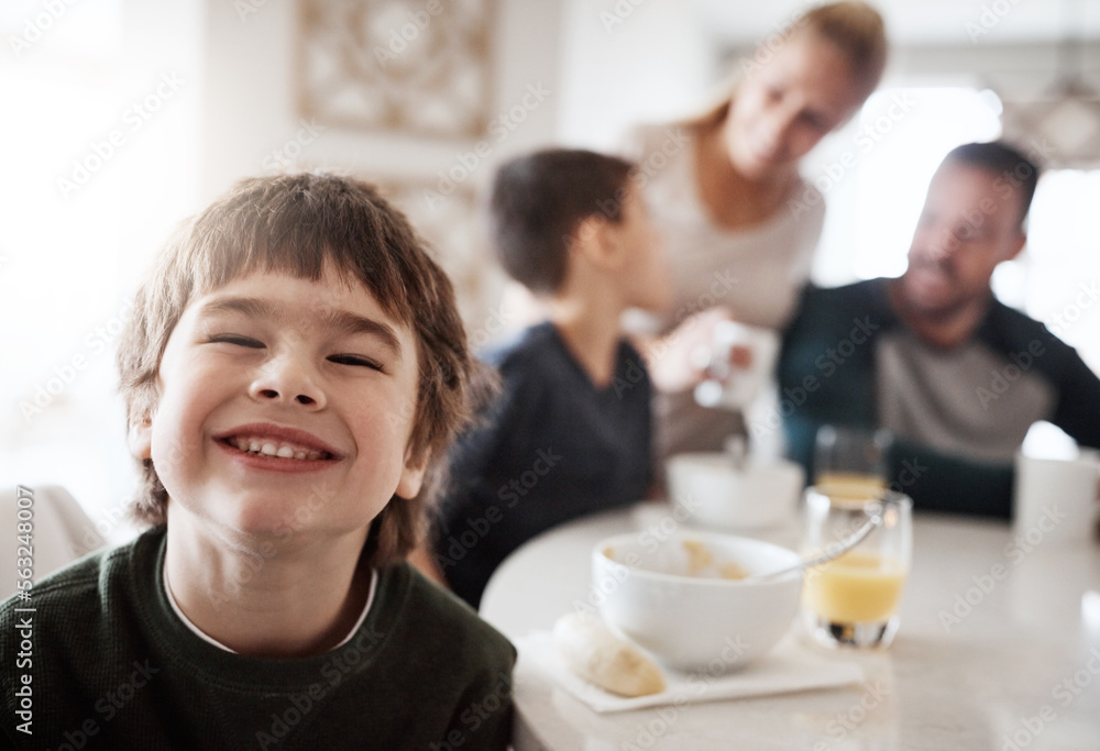 Happy, breakfast and portrait of boy with family for at kitchen table for food, child development an